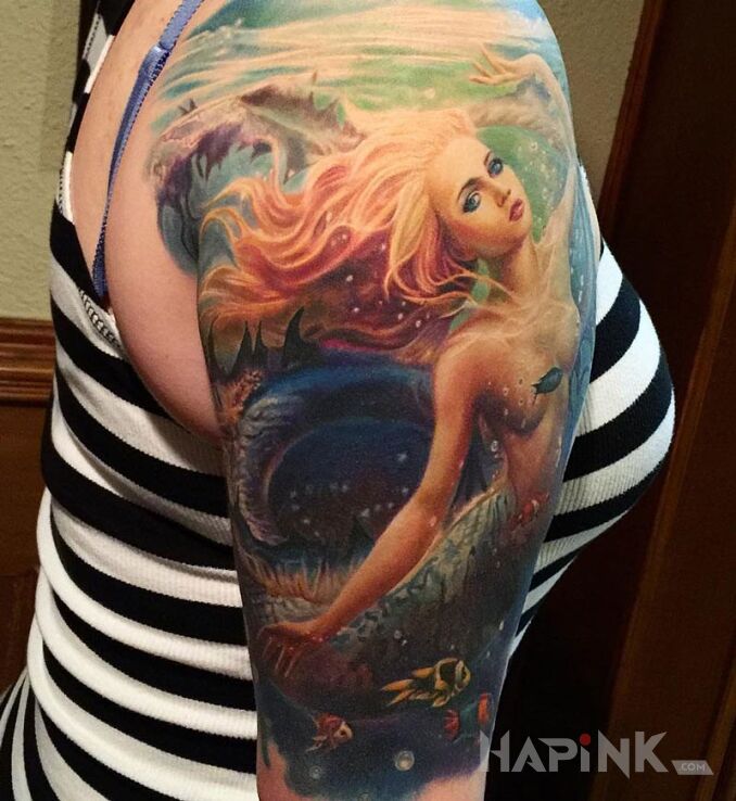 Tattoo Syrena in characters motif on the upper arm