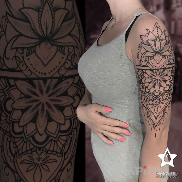 Tattoo Mandala in black and gray motif and graphic / illustrative style on the upper arm
