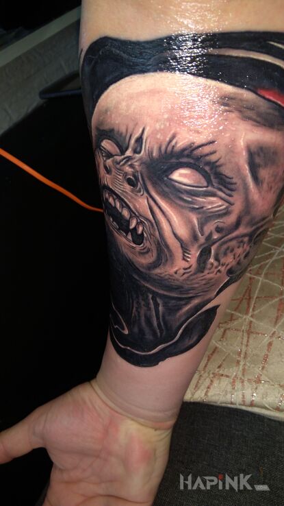 Tattoo Demon in demons motif and realistic style on the forearm