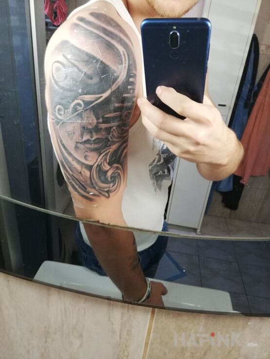 Tattoo Schody in black and gray motif and realistic style on the upper arm