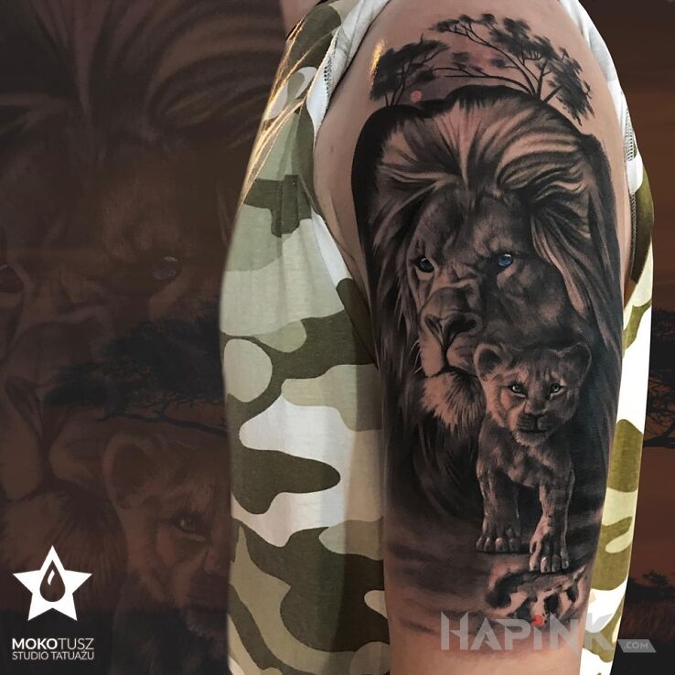 Tattoo Dwa Lwy in black and gray motif and realistic style on the upper arm