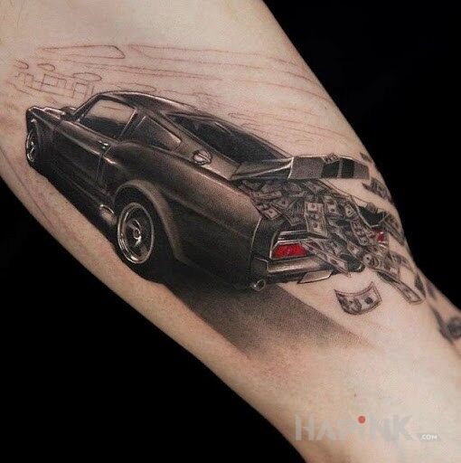 Tattoo Pędzący samochód in black and gray motif and realistic style on the bicep