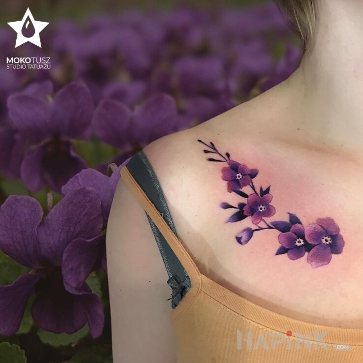 Tattoo Flower power in colorful motif and realistic style on the collarbone
