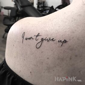 Tattoo I will not give up on the shoulder blades motif: lettering style: calligraphy