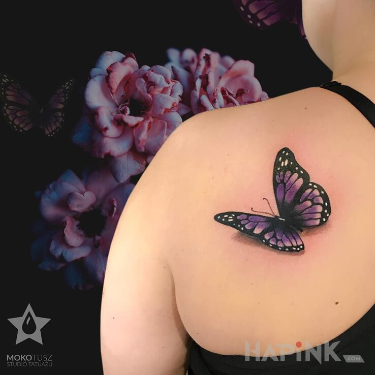 Tattoo Butterfly Tattoo in colorful motif and realistic style on the shoulder blades