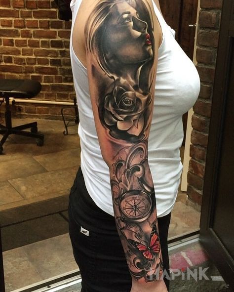 Tattoo Kobieca twarz i kompas in flowers motif and realistic style on the forearm