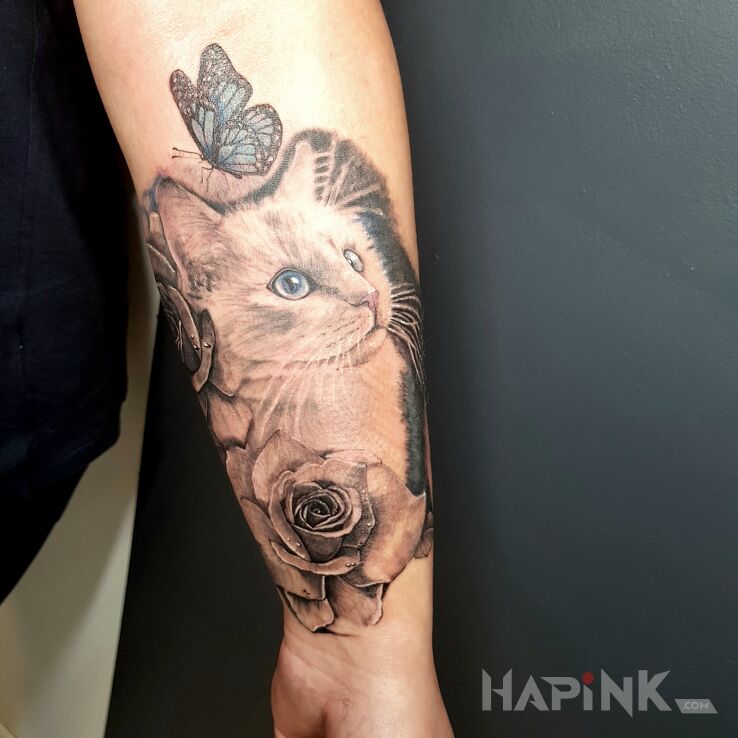 Tattoo Kicia in butterflies motif and realistic style on the forearm