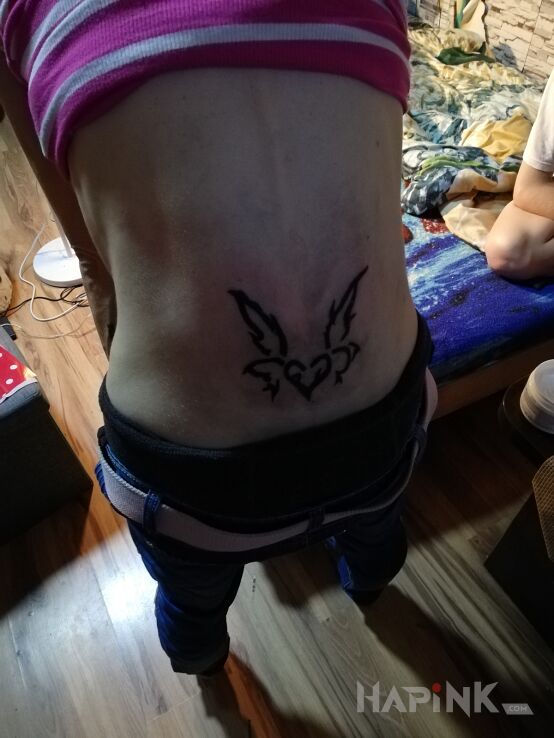 Tattoo Serce in other motif and tribal style on the back