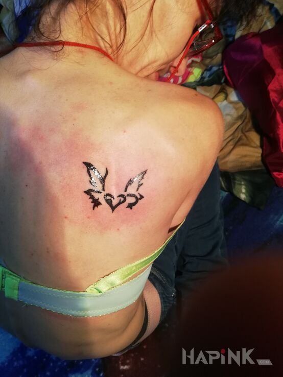 Tattoo Serce in other motif and tribal style on the shoulder blades
