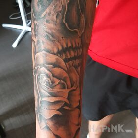 Tattoo Skull with a rose on the forearm motif: skulls style: realistic