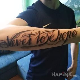 Tattoo Never Lose Hope on the forearm motif: lettering style: calligraphy