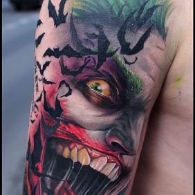 Tattoo Jocker on the upper arm motif: faces style: realistic
