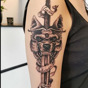 Tattoo Wolf, dagger on the upper arm motif: objects style: graphic / illustrative