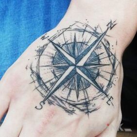 Tattoo Wind Rose. on the hand motif: black and gray style: sketch
