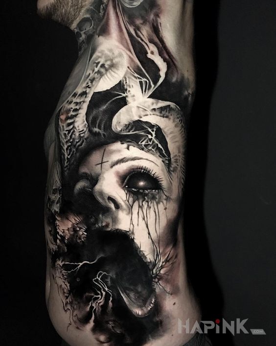 Tattoo Przerażająca twarz in black and gray motif and realistic style on the stomach