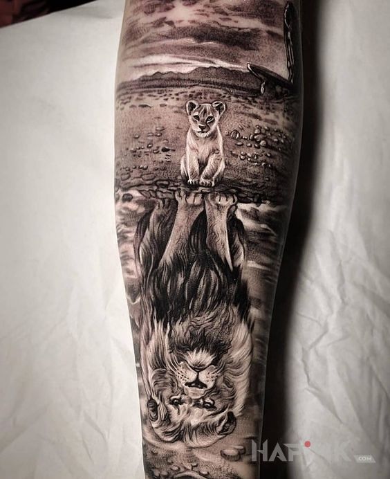 Tattoo Mufasa i Simba in black and gray motif and realistic style on the forearm