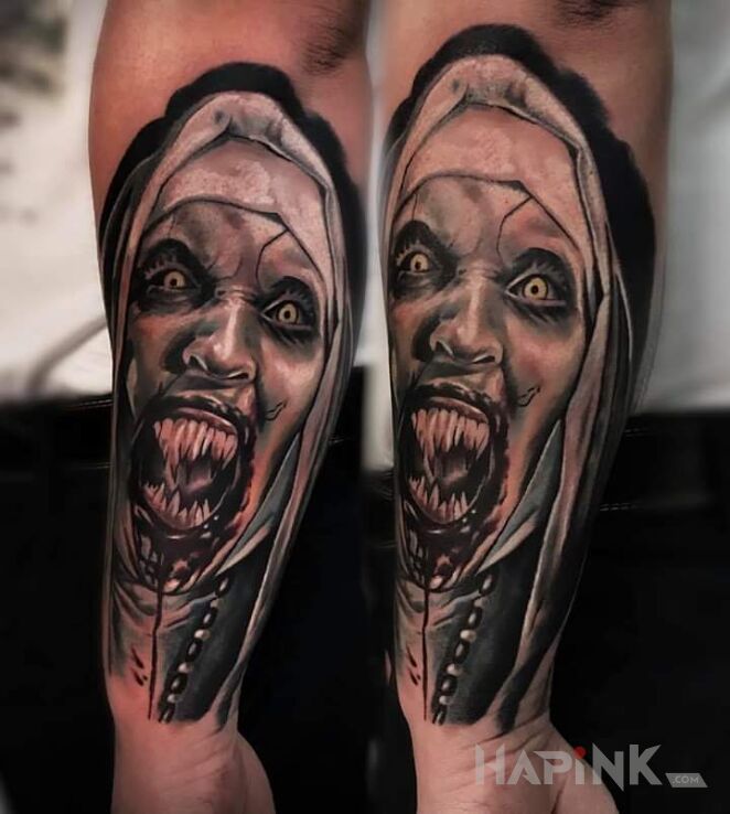 Tattoo Słynna "The Nun" in faces motif and realistic style on the forearm