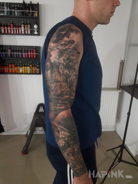 Tattoo Patriotyczny in faces motif and realistic style on the upper arm