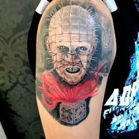 Tattoo Pinhead on the upper arm motif: faces style: realistic