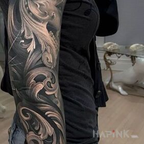 Tattoo Woman in a mask on the upper arm motif: black and gray style: realistic