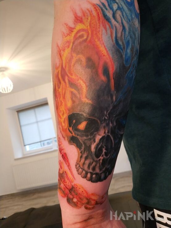Tattoo Ghost Rider in demons motif and realistic style on the forearm