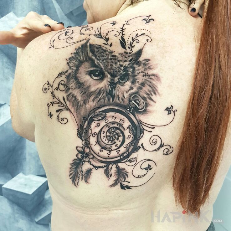 Tattoo Sowka in black and gray motif and realistic style on the shoulder blades