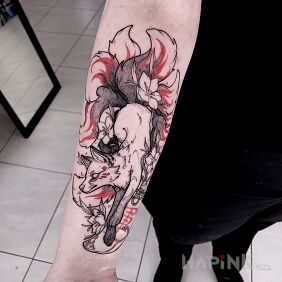 Tattoo Japan fox on the forearm motif: black and gray style: graphic / illustrative