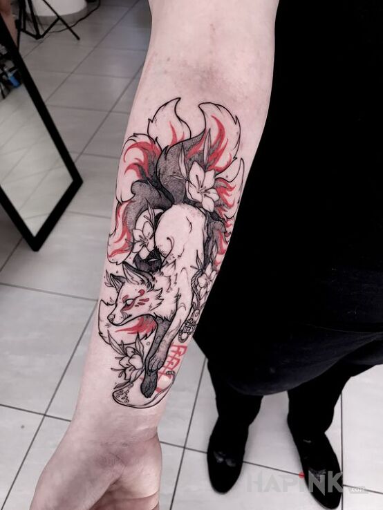 Tattoo Japan fox in black and gray motif and graphic / illustrative style on the forearm
