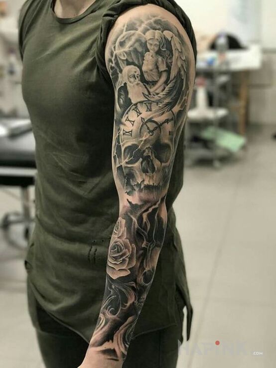 Tattoo Aniołek nad czaszką in skulls motif and realistic style on the forearm