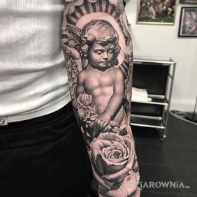 Tatuaż Boski cherubin na przedramieniu motyw: kwiaty styl: realistyczne