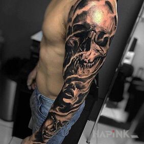 Tattoo Two faces and a skull on the upper arm motif: black and gray style: realistic