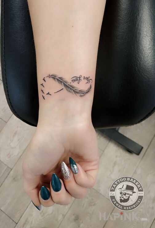 Tattoo Nieskończoność in black and gray motif and graphic / illustrative style on the forearm
