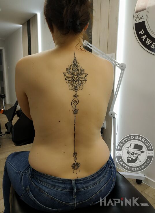 Tattoo Lotos in flowers motif and graphic / illustrative style on the back