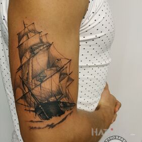 Tattoo Ship on the upper arm motif: black and gray style: realistic