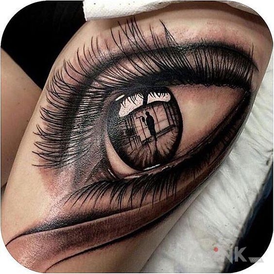 Tattoo Oko in black and gray motif and realistic style on the leg