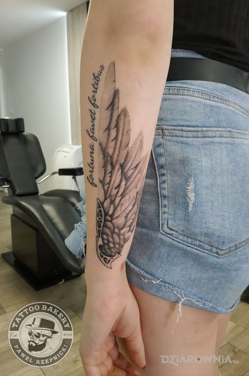 Tatuaż skrzydło w motywie napisy i stylu realistyczne na przedramieniu