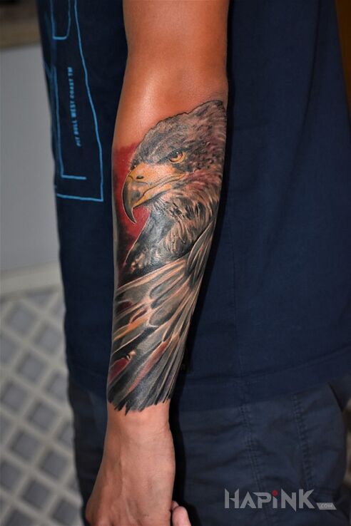 Tattoo Orzeł :) in colorful motif and realistic style on the forearm