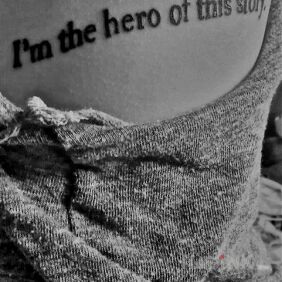 Tattoo I am a hero on the ribs motif: lettering style: calligraphy