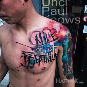 Tattoo Alive or just breathing on the chest motif: lettering