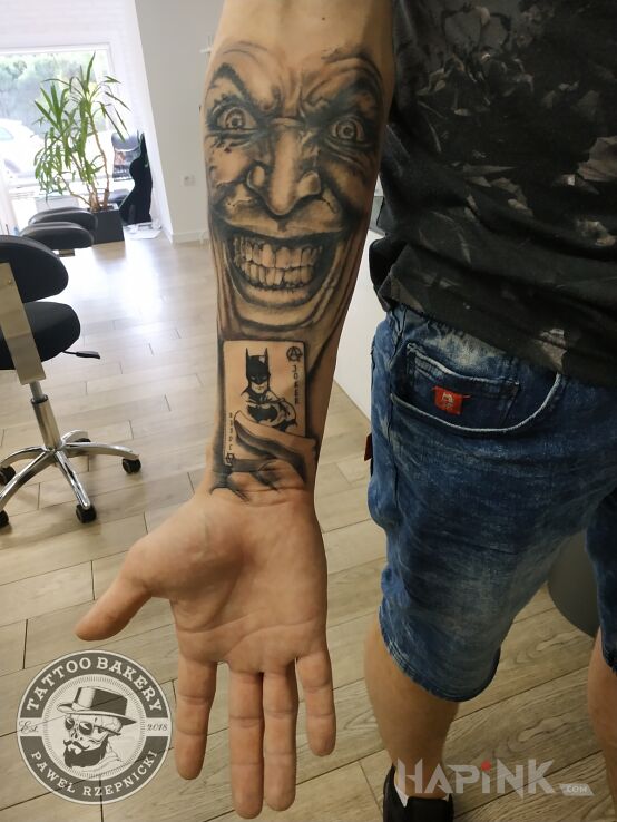 Tattoo Joker in black and gray motif and realistic style on the forearm