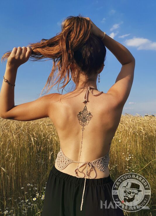 Tattoo Lotos in ornaments motif and graphic / illustrative style on the back