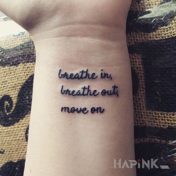 Tattoo Wdech i wydech in lettering motif and calligraphy style on the wrist
