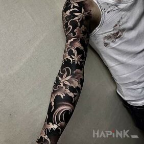 Tattoo Cherry blossoms in the wind on the forearm motif: black and gray style: blackwork / blackout
