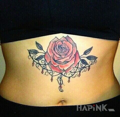 Tattoo Róża in flowers motif on the stomach