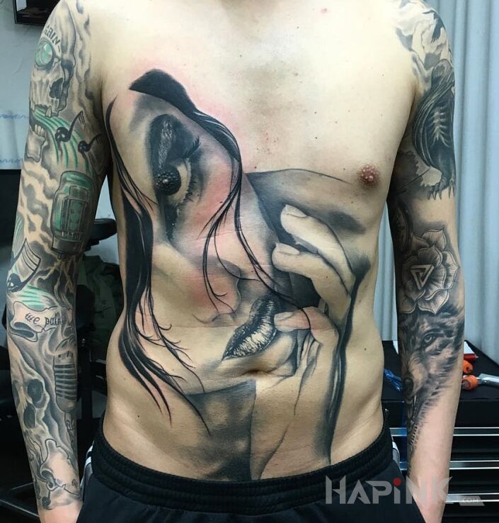Tattoo Portret in characters motif on the stomach