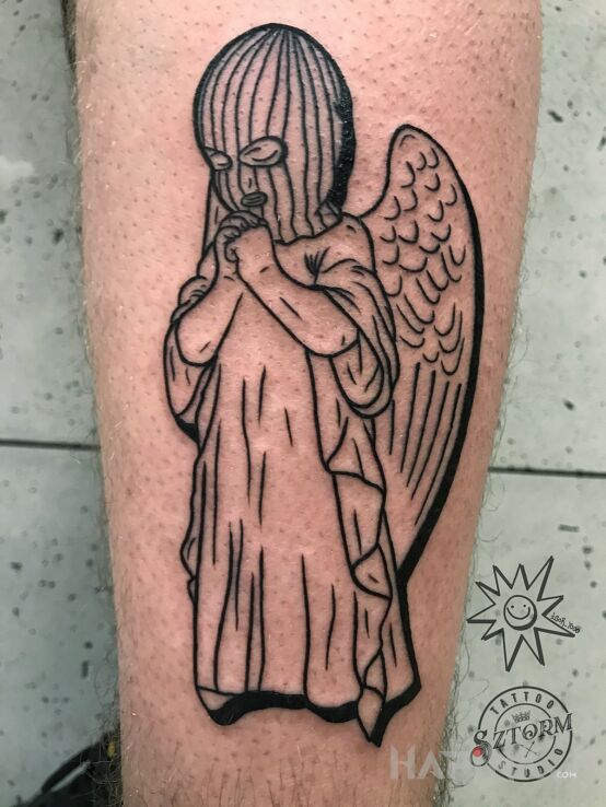 Tattoo Angel on the street. in black and gray motif and contour / linework style on the calf