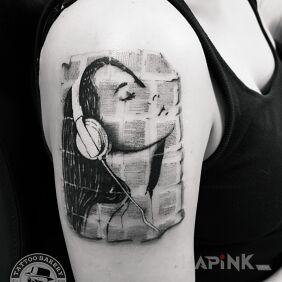 Tattoo Music on the upper arm motif: faces style: graphic / illustrative