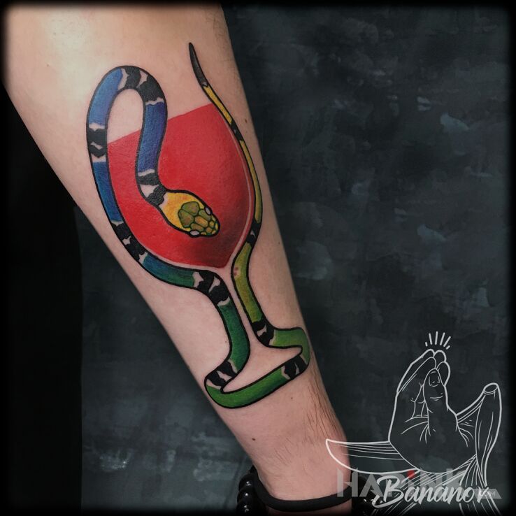 Tattoo Wąż i Wino in colorful motif and newschool style on the forearm