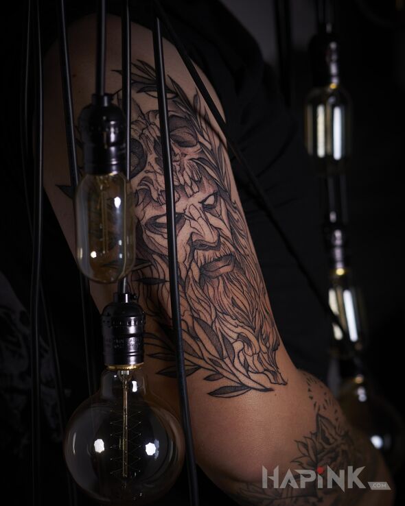 Tattoo Skull in faces motif and sketch style on the upper arm