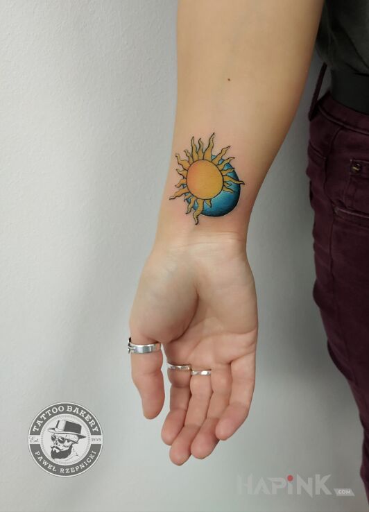Tattoo Słońce księżyc in colorful motif and graphic / illustrative style on the forearm